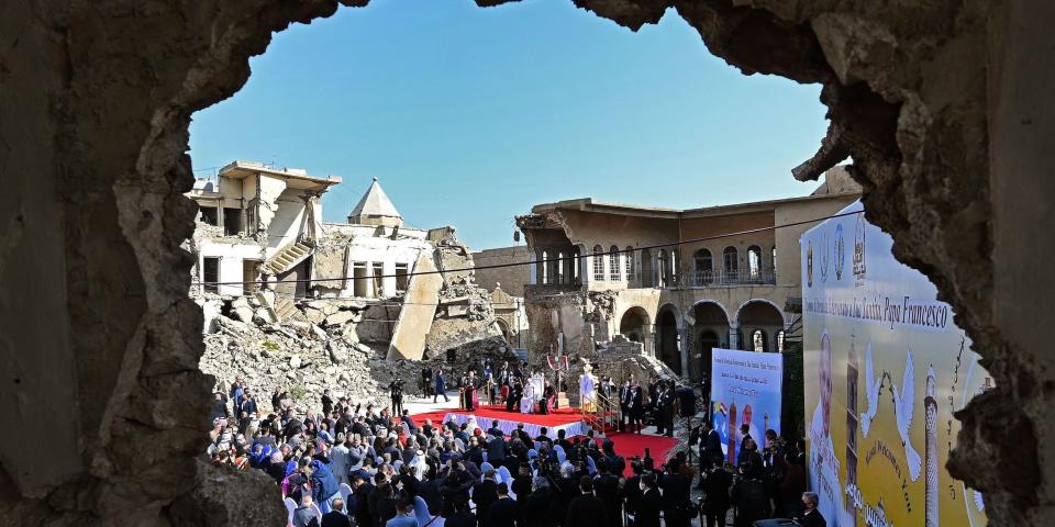 Pope Francis speaks at a square near the ruins of the Syriac Catholic Church of the Immaculate Conception (al-Tahira-l-Kubra), in the old city of Iraq's northern Mosul on March 7, 2021. - Pope Francis, on his historic Iraq tour, visits today Christian communities that endured the brutality of the Islamic State group until the jihadists' "caliphate" was defeated three years ago (Photo by Vincenzo PINTO / AFP) (Photo by VINCENZO PINTO/AFP via Getty Images)