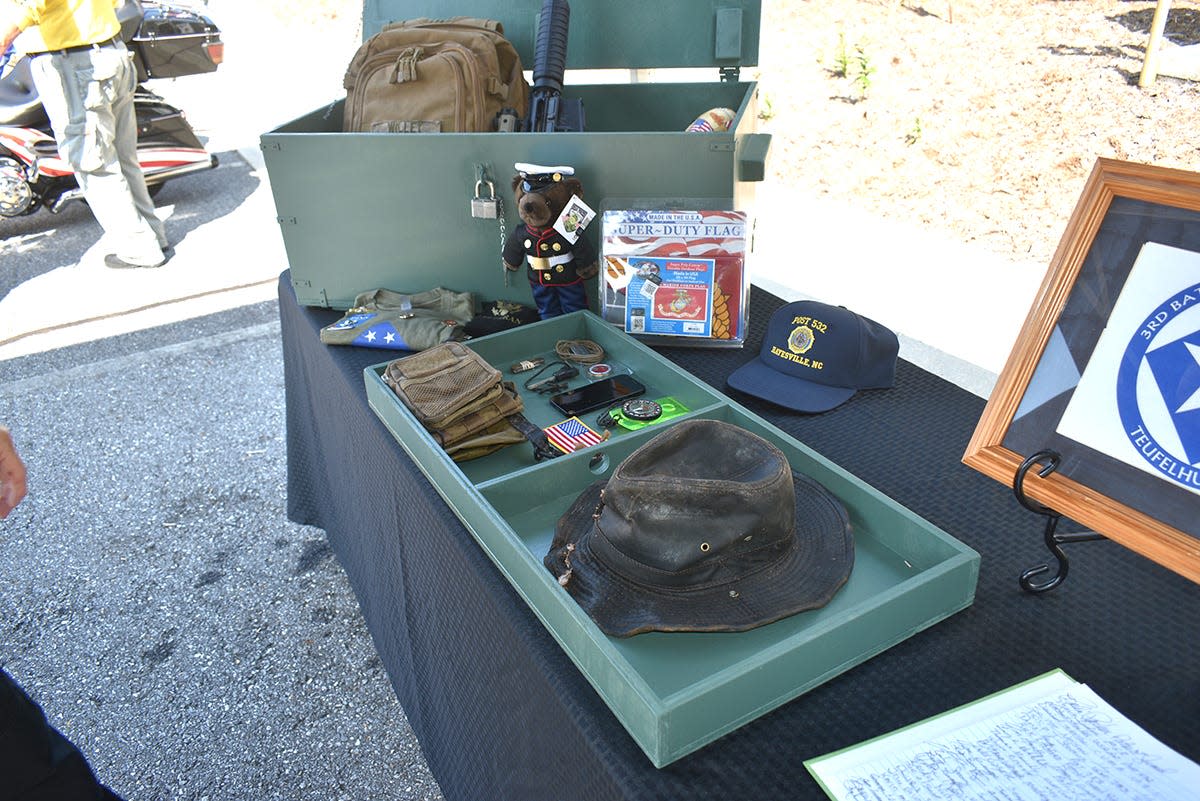 Belongings found at a campsite off the Appalachian Trail in Clay County, North Carolina, as well as some donated items, were returned to the family of veteran Sean Willey, a lance corporal in the United States Marine Corps, in a replica of a Marine Corps footlocker handcrafted by a Marine veteran in Georgia. Here they are spread out during a memorial service for Willey held outside the Clay County Sheriff's Office on July 27, 2023, the day before Willey's remains and his possessions were escorted back to Ilion by a convoy of deputies, state police and veterans.