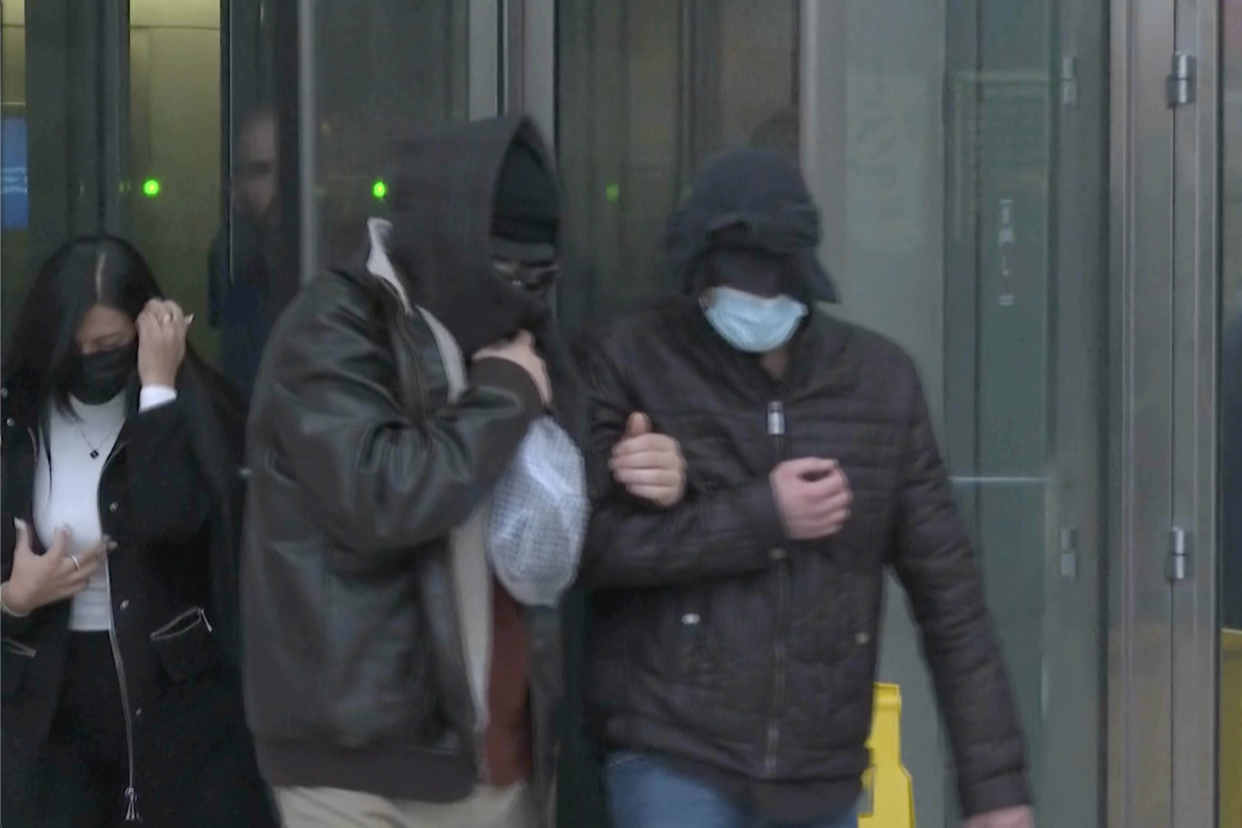 Former FBI informant Alexander Smirnov, second from right, leaves the federal courthouse in Las Vegas on Feb. 20. (Screengrab via AP) 