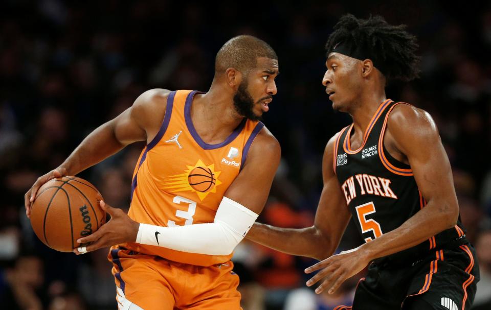 New York Knicks' Immanuel Quickley (5) guards Phoenix Suns' Chris Paul (3) during the first half of an NBA basketball game Friday, Nov. 26, 2021, in New York. AP Photo/John Munson)