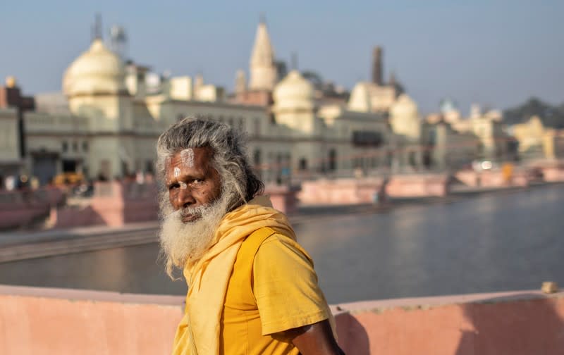 A Hindu priest leaves after performing prayers on the banks of Sarayu river after Supreme Court's verdict on a disputed religious site, in Ayodhya