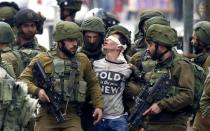 <p>Israeli forces detain a Palestinian protester during clashes in Hebron, West Bank on Dec. 7, 2017, that followed protests against a decision by President Donald Trump to recognize Jerusalem as the capital of Israel. (Photo: APAImages/REX/Shutterstock) </p>