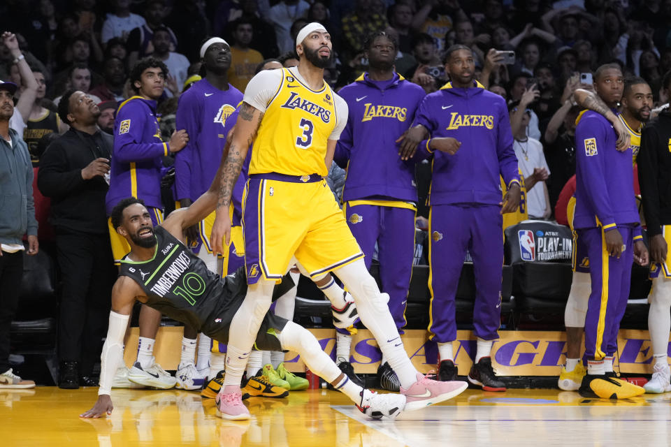 Minnesota Timberwolves guard Mike Conley (10) is fouled, on a 3-point shot, by Los Angeles Lakers forward Anthony Davis (3) in the final second of regulation in an NBA basketball play-in tournament game Tuesday, April 11, 2023, in Los Angeles. Conley made three free throws to send the game into overtime. (AP Photo/Marcio Jose Sanchez)