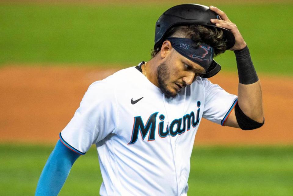 Miami Marlins shortstop Miguel Rojas (19) reacts to being caught stealing third base during the first inning of an MLB game against the San Francisco Giants at loanDepot park in the Little Havana neighborhood of Miami, Florida, on Sunday, April 18, 2021.