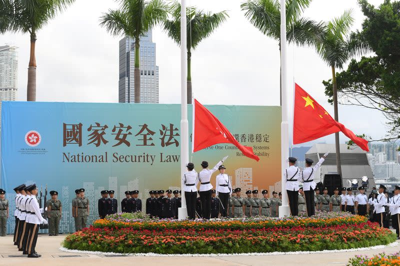 Chinese and Hong Kong flags are raised at the flag-raising ceremony for the 23rd anniversary of the establishment of the Hong Kong Special Administrative Region