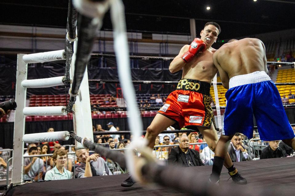 Jorge Tovar, red gloves, and Tavorua Teague blue gloves, compete in the main event during the School of Hard Knocks boxing match at Pan American Center on Friday, Aug. 12, 2022. 