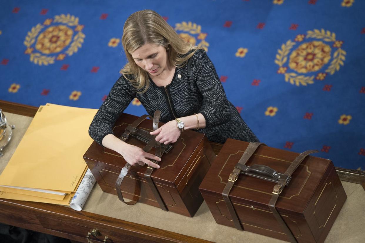 <span class="caption">A congressional staffer opens the boxes containing the Electoral College ballots in January 2017.</span> <span class="attribution"><a class="link " href="https://www.gettyimages.com/detail/news-photo/aide-opens-electoral-college-ballot-boxes-during-a-joint-news-photo/631096338" rel="nofollow noopener" target="_blank" data-ylk="slk:Tom Williams/CQ Roll Call;elm:context_link;itc:0;sec:content-canvas">Tom Williams/CQ Roll Call</a></span>