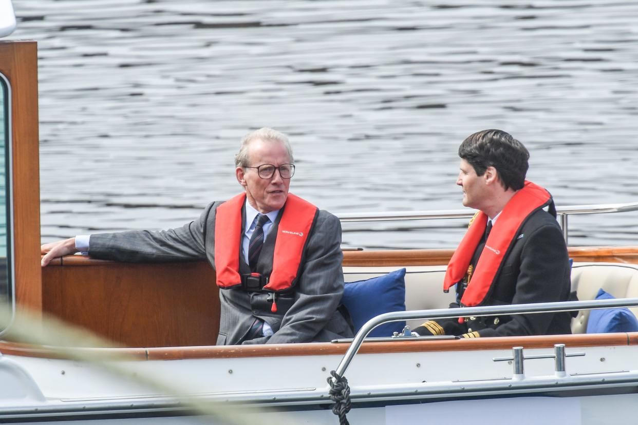 Andrew Havill (left) is seen on a boat made to look like a royal yacht tender in the harbor during filming for the Netflix series "The Crown" on Aug. 2, 2021, in Macduff, Scotland.