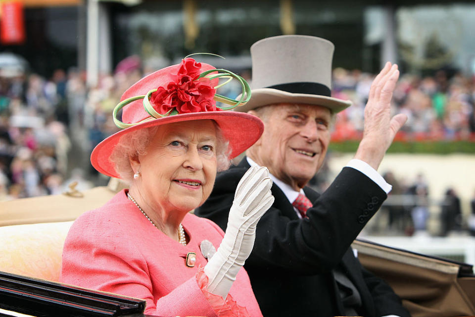 Queen Elizabeth ll and Prince Philip, Duke of Edinburgh wave from an open carriage on Ladies Day at Royal Ascot on June 16, 2011 in Ascot, England.