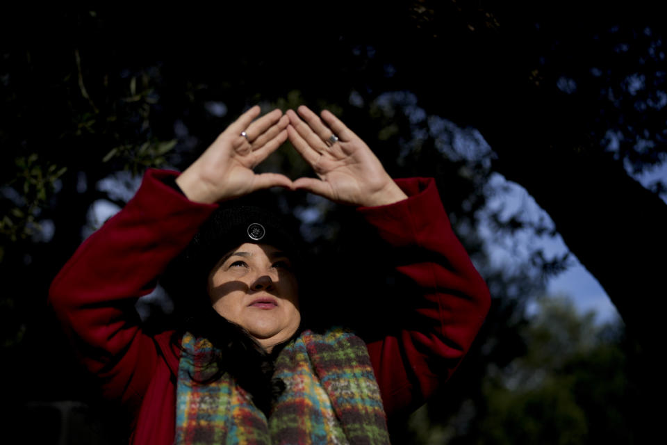 Brazilian Gilma Ribeiro watches the sun as she pauses for a moment inside the Pueblo Encanto spiritual theme park in Capilla del Monte, Argentina, Wednesday, July 19, 2023. In the pope’s homeland of Argentina, Catholics have been renouncing the faith and joining the growing ranks of the religiously unaffiliated. Commonly known as the “nones,” they describe themselves as atheists, agnostics, spiritual but not religious, or simply: “nothing in particular.” (AP Photo/Natacha Pisarenko)