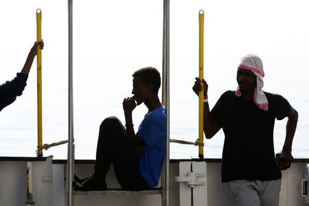 Migrants are seen resting on board the MV Aquarius rescue ship run by SOS Mediterranee organisation and Doctors Without Borders during a search and rescue (SAR) operation in the Mediterranean Sea, off the Libyan Coast, August 12, 2018. Picture taken August 12, 2018. REUTERS/Guglielmo Mangiapane