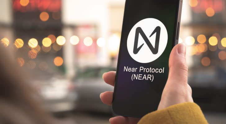 NEAR Protocol (NEAR-USD) logo on a smartphone held in person's hand