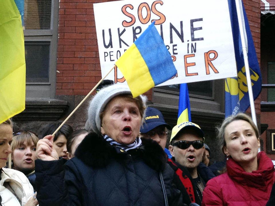 CORRECTS TO UKRAINIAN CONSULATE INSTEAD OF EMBASSY - Maria Semkiv, 66, gathers with others outside the Ukrainian Consulate in Chicago, Wednesday, Feb. 19, 2014, to protest the deadly violence in the Ukraine capital of Kiev and call for a stronger response by the United States and the European Union. Clashes on Tuesday left 25 people dead in the worst violence in nearly three months of anti-government protests in Ukraine's capital. Protests began after the president backed away from a deal to join the European Union. (AP Photo/Tammy Webber)