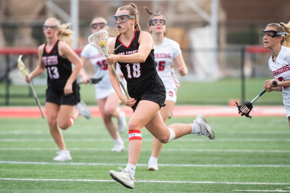 South Western senior midfielder Leah Leonard (18) runs down field during a YAIAA lacrosse game against Susquehannock at Susquehannock High School on April 6, 2023, in Glen Rock. Leonard finished the night with two goals to help the Mustangs win, 7-6.