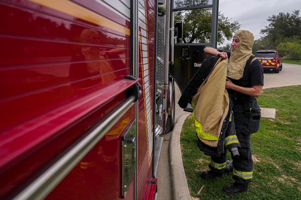 Priscilla Coffman, a firefighter and paramedic, suits up for drills at Georgetown Fire Station No. 5. "Anybody can do this job as long as you're willing to push yourself," she said.