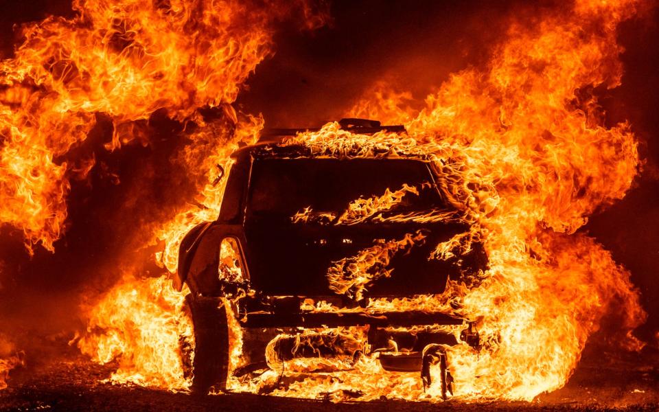 A car ablaze at the LNU Complex fire near Vacaville - GETTY IMAGES