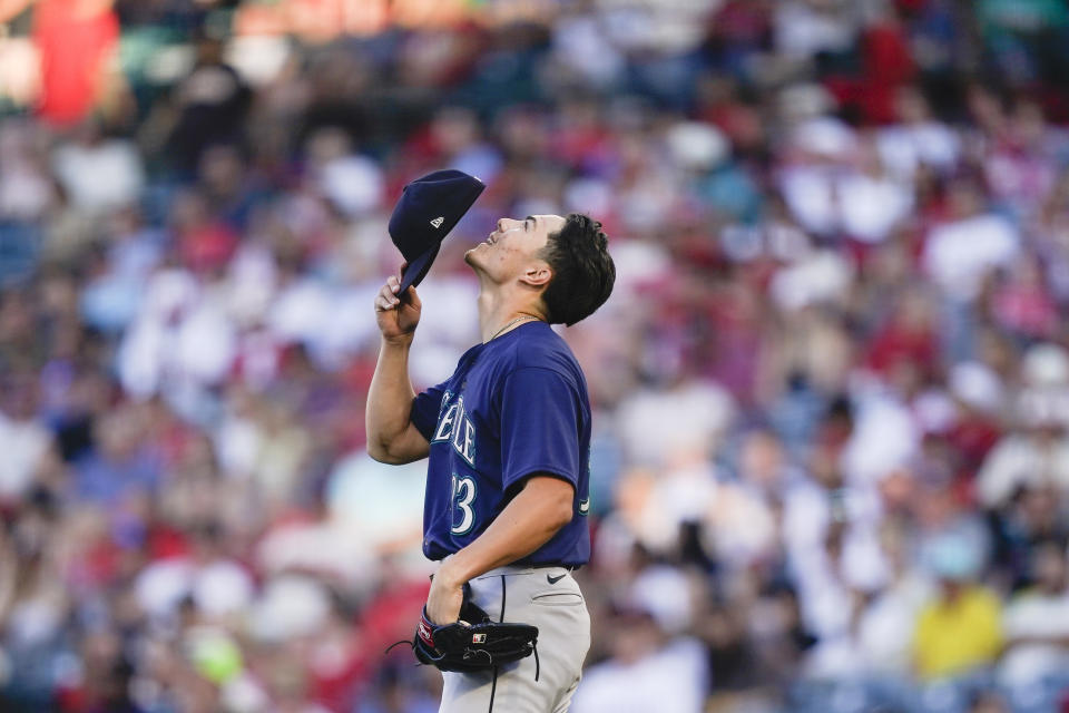 Seattle Mariners starting pitcher Bryan Woo looks up before taking the mound in the first inning of the team's baseball game against the Los Angeles Angels, Thursday, Aug. 3, 2023, in Anaheim, Calif. (AP Photo/Ryan Sun)