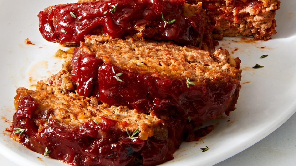 meatloaf sliced and topped with rosemary