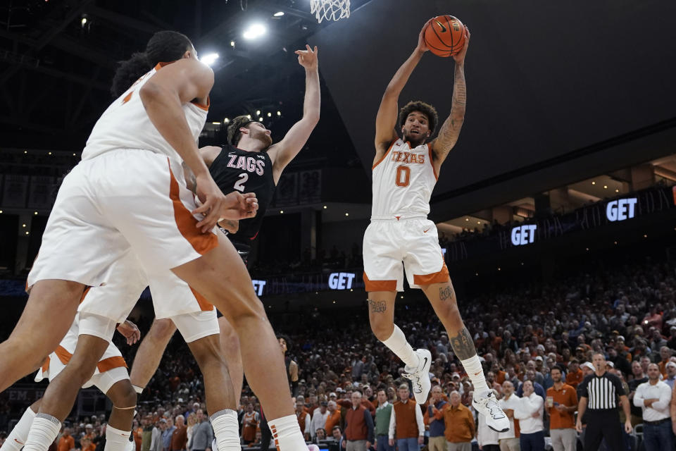 Texas forward Timmy Allen (0) grabs a rebound over Gonzaga forward Drew Timme (2) during the first half of an NCAA college basketball game, Wednesday, Nov. 16, 2022, in Austin, Texas. (AP Photo/Eric Gay)