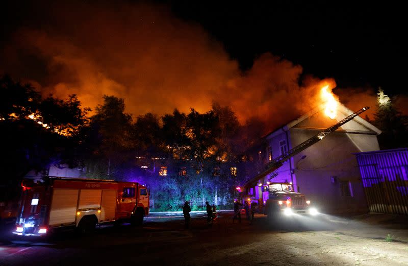 Firefighters extinguish a fire in the university building following a reported shelling in Donetsk