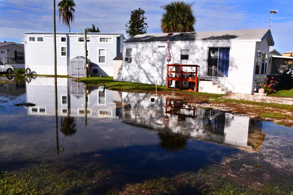 Standing water along South Banana River Drive on Merritt Island sits in yards. Heavy rains pounded Brevard Wednesday night, flooding some streets and yards.