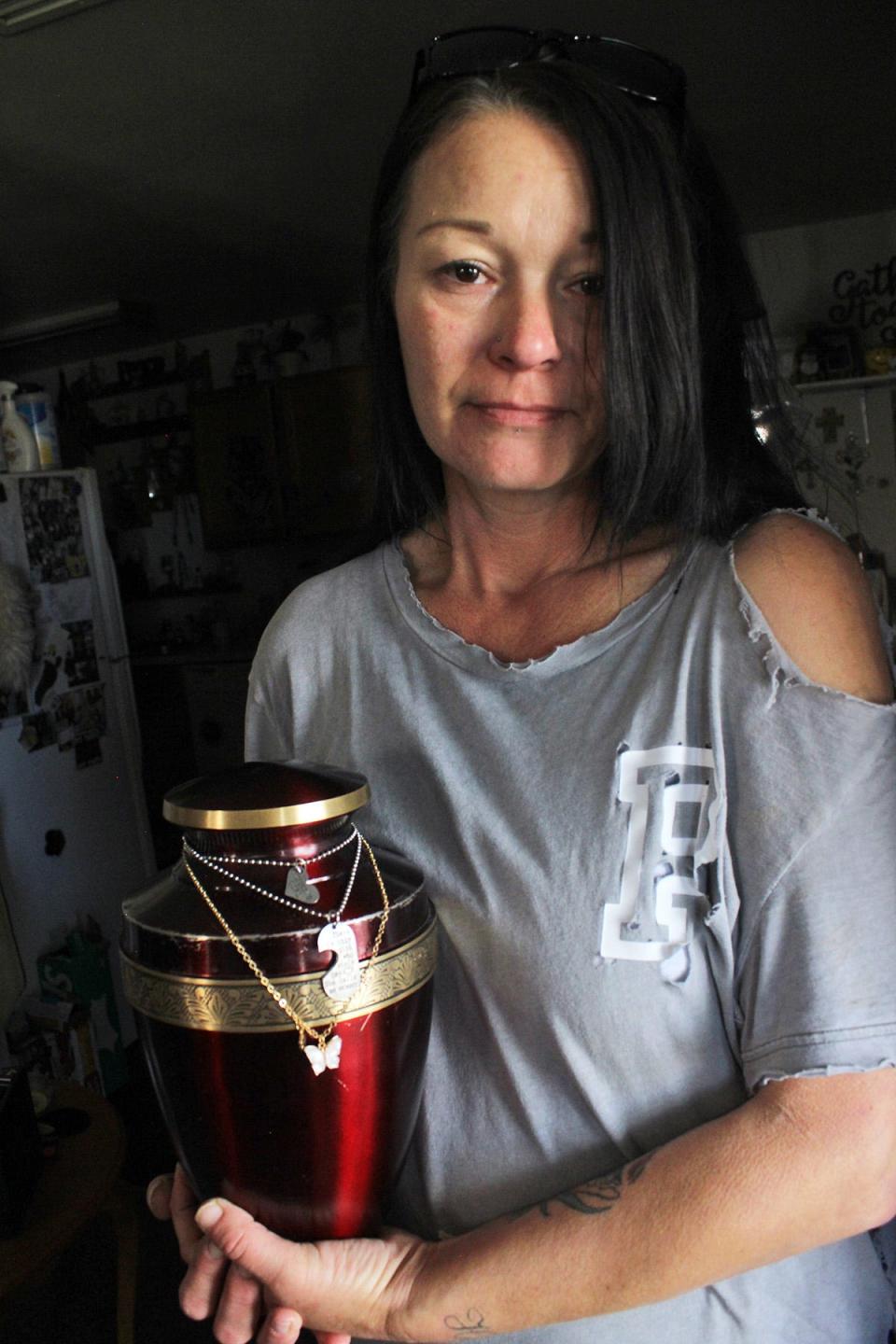 Tanya Perkins holds an urn containing the ashes of her daughter, Hailey, 13, who was murdered in Pueblo West June 27, 2022.