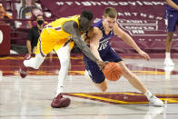 Minnesota's Both Gach, left, and Northwestern's Miller Kopp chase the ball in the second half of an NCAA college basketball game, Thursday, Feb. 25, 2021, in Minneapolis. (AP Photo/Jim Mone)