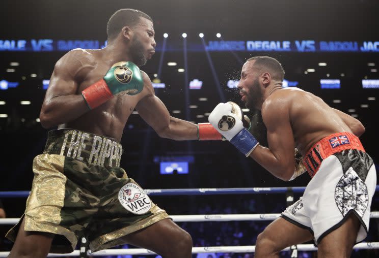 Badou Jack (L) lands a left hand on James DeGale during their super middleweight title fight Saturday in Brooklyn. (The Associated Press)