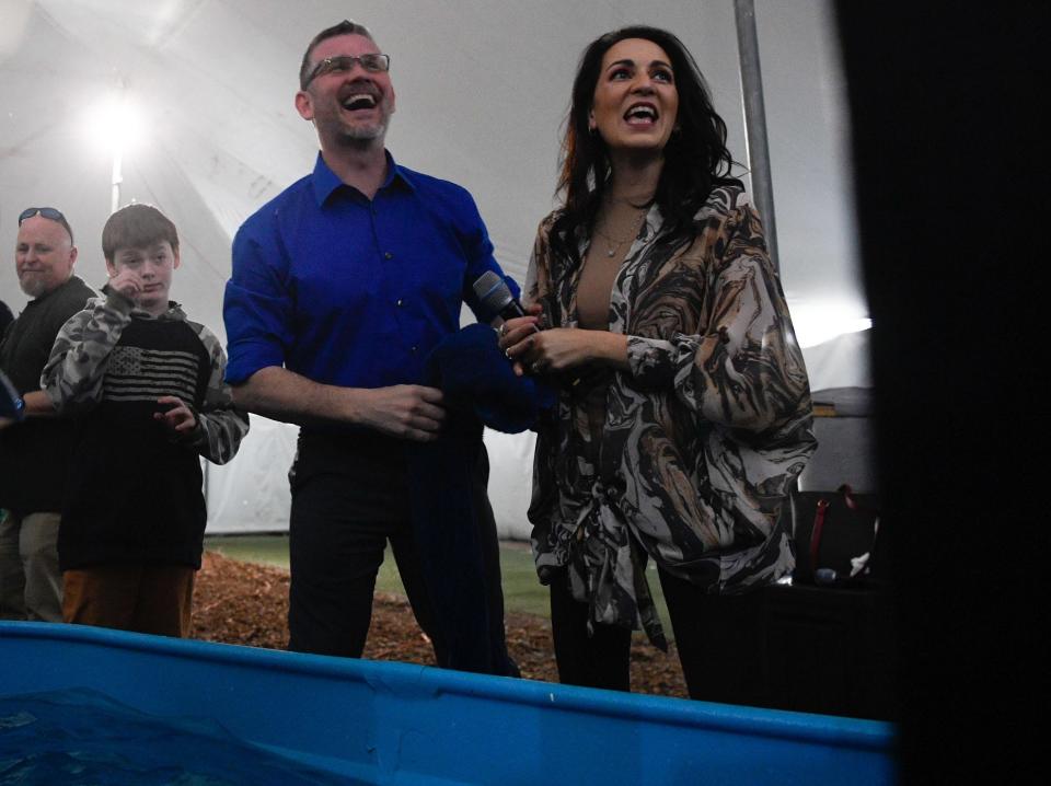 Greg and Taisha Locke converse with a member of the church before they baptize them at the Global Vision Bible Church in Mt. Juliet, Tenn., Sunday, April 3, 2022.