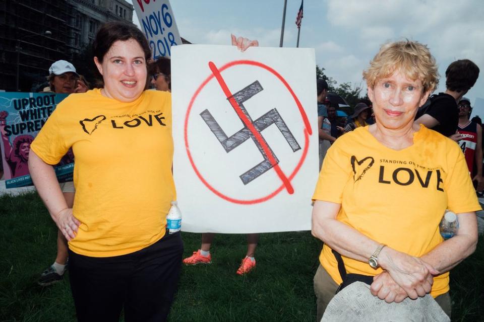 Two counter-protesters attend a demonstration, in opposition of the Unite the Right 2 rally, at Freedom Plaza.