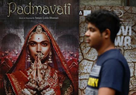 A man walks past a poster of the upcoming Bollywood movie 'Padmavati' outside a theatre in Mumbai, India, November 21, 2017. REUTERS/ Danish Siddiqui