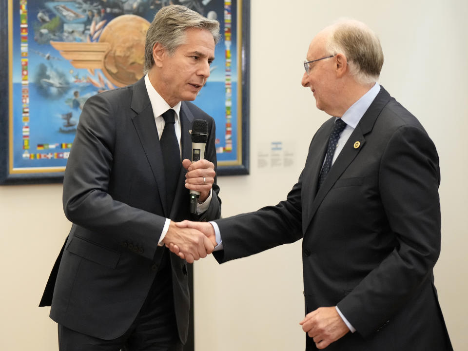 US Secretary of State Antony Blinken shakes hands with International Civil Aviation Organization (ICAO) President Salvatore Sciacchitano after speaking with members of the organization in Montreal, Friday, Oct. 28, 2022. (Ryan Remiorz /The Canadian Press via AP)