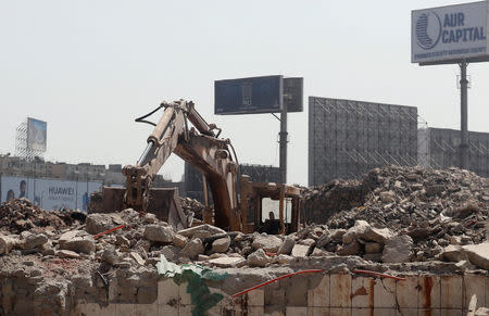 A digger is seen as a slum is demolished, behind the Egyptian Radio and Television Union (ERTU) headquarters in the so-called "Maspero Triangle" in Cairo, Egypt, September 13, 2018. REUTERS/Amr Abdallah Dalsh