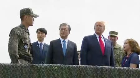 U.S. President Donald Trump and South Korean President Moon Jae-in are seen at the demilitarized zone (DMZ) separating the two Koreas, in Paju