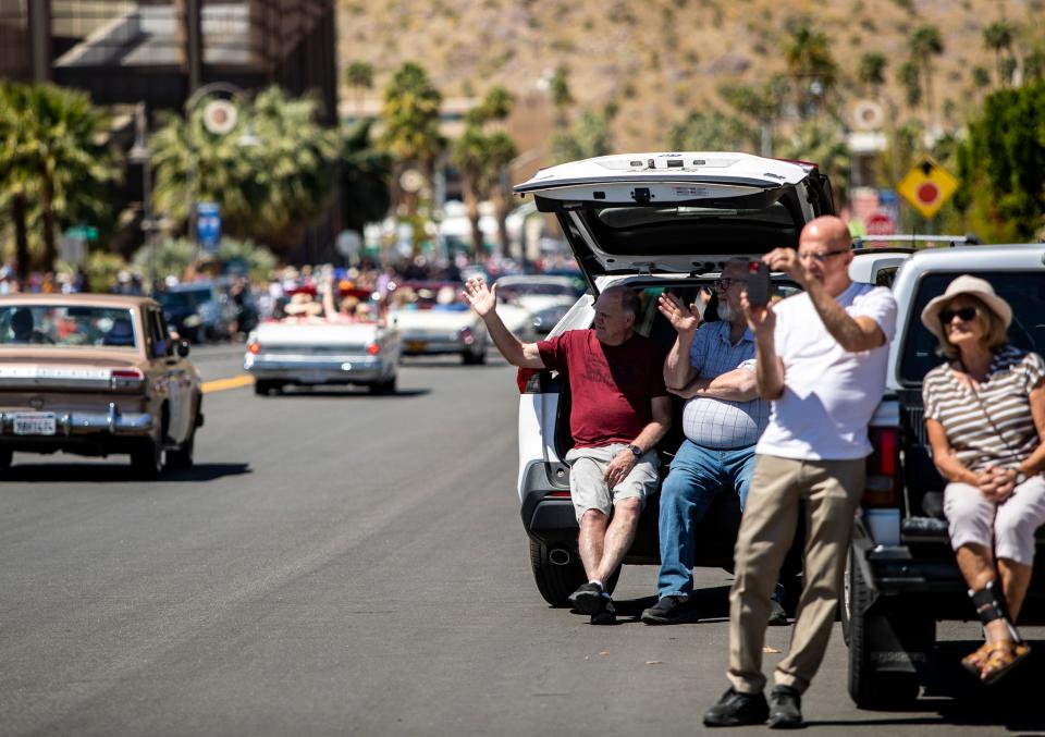 Spectators wave to cars in a parade Saturday celebrating Palm Springs' 85th birthday.