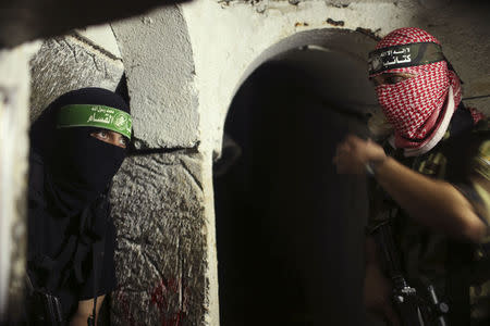 Palestinian fighters from the Izz el-Deen al-Qassam Brigades, the armed wing of the Hamas movement, are seen inside an underground tunnel in Gaza August 18, 2014. REUTERS/Mohammed Salem