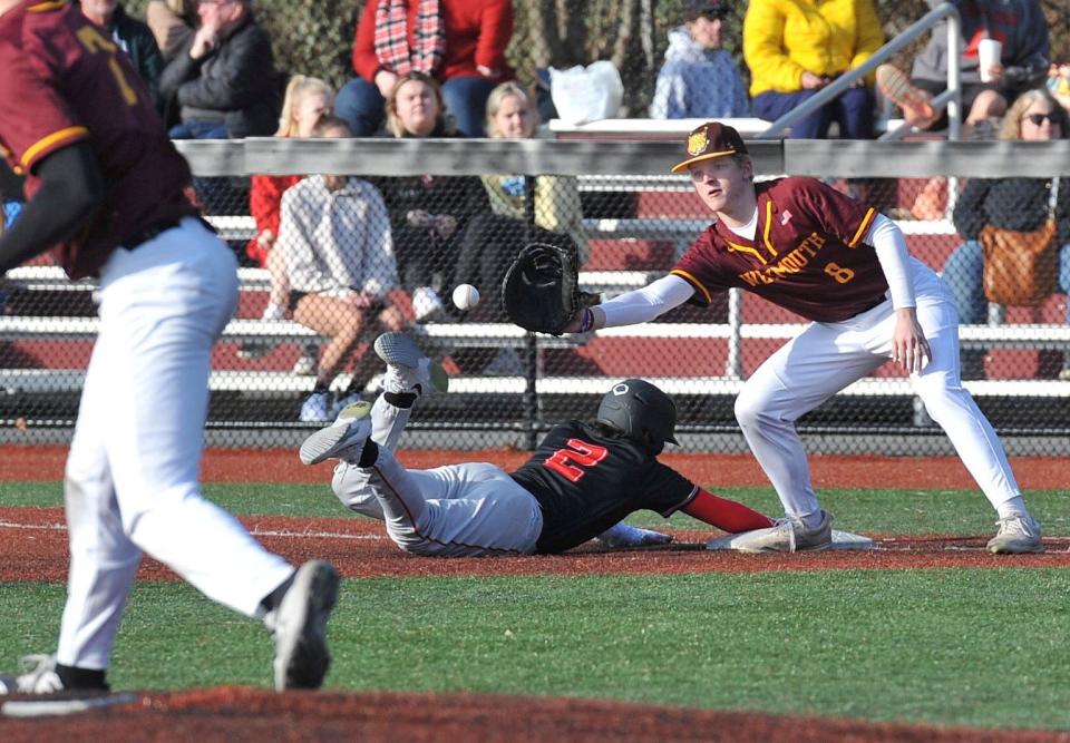 North Quincy's Vinny O'Leary slides safely back to first as Weymouth first baseman Andrew Ferguson takes the throw during high school baseball at Libby Field in Weymouth, Tuesday, April 4, 2023.