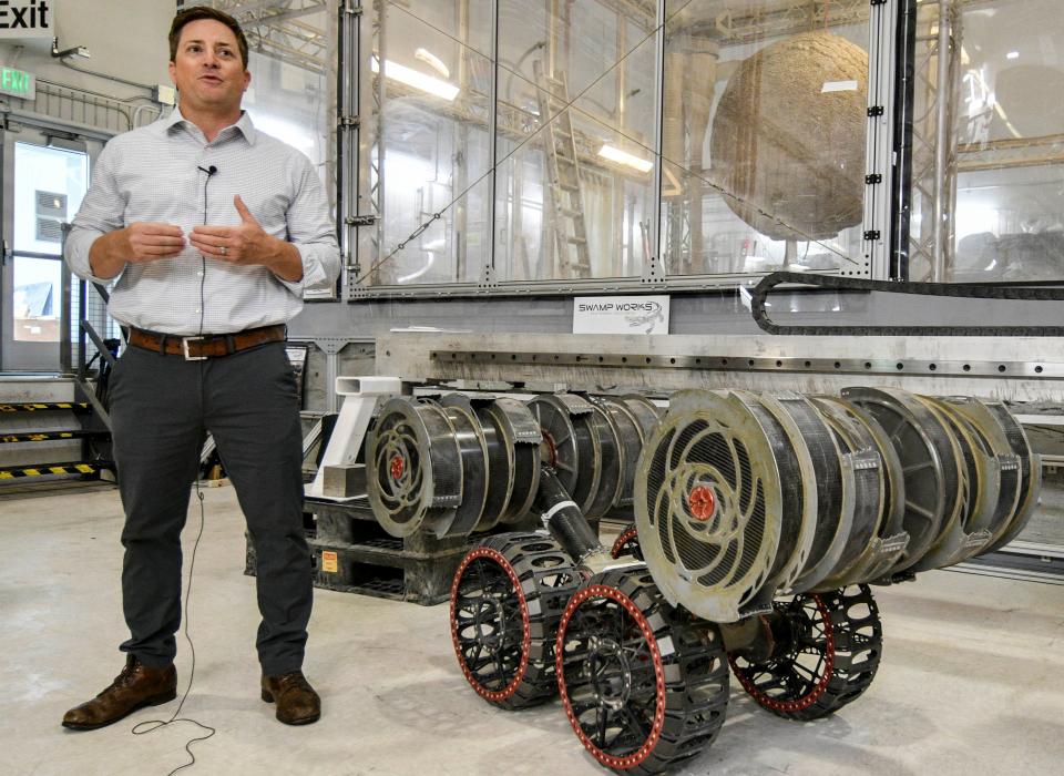 Nathan Gelino, principal investigator at Kennedy Space Centerâ€™s Swamp Works research facility, talks about the work they do on June 14, 2022. Next to him is a rover being developed for possible use on a future mission. Mandatory Credit: Craig Bailey/FLORIDA TODAY via USA TODAY NETWORK