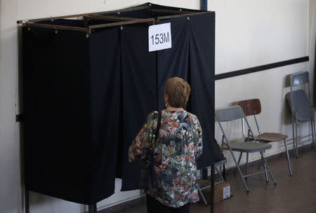 Chilean president Michelle Bachelet walk to a booth to cast her ballot for the presidential election in Santiago, Chile, December 17, 2017. REUTERS/Carlos Vera