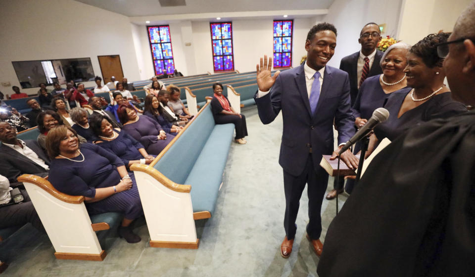 Jeremy Gray takes an oath at Greater Peace Missionary Baptist Church in Opelika, Ala., Nov. 7, 2018, after winning the election to the Alabama Legislature. Gray of Opelika is seeking the Democratic nomination for Alabama 2nd Congressional District. (Emily Enfinger/Opelika-Auburn News via AP)