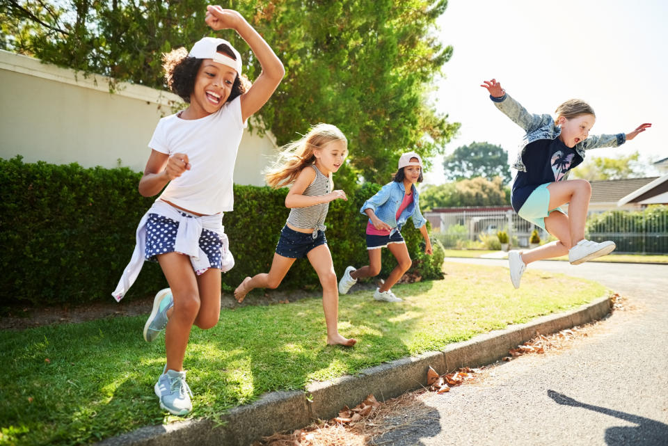 Group of children happily playing and jumping outdoors