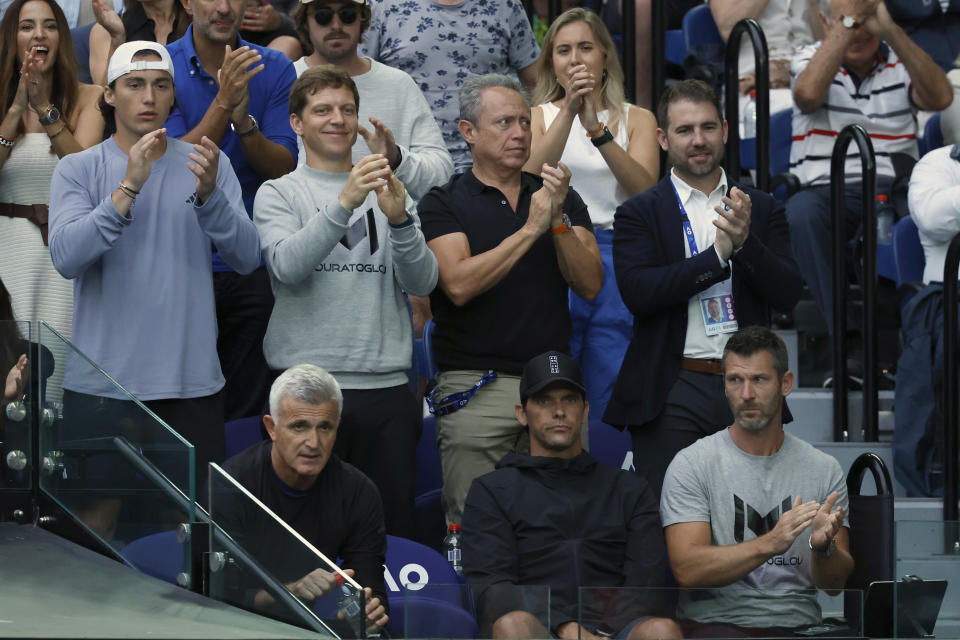 The team box for Stefanos Tsitsipas of Greece, including his father, Apostolos Tsitsipas, bottom left, watch as he plays Novak Djokovic of Serbia during the men's singles final at the Australian Open tennis championships in Melbourne, Australia, Sunday, Jan. 29, 2023. (AP Photo/Asanka Brendon Ratnayake)