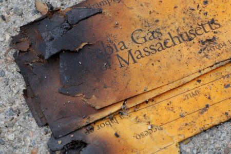 FILE PHOTO: A burnt Columbia Gas of Massachusetts envelope sits on the sidewalk outside a home burned during a series of gas explosions in Lawrence, Massachusetts, U.S., September 14, 2018.   REUTERS/Brian Snyder/File Photo