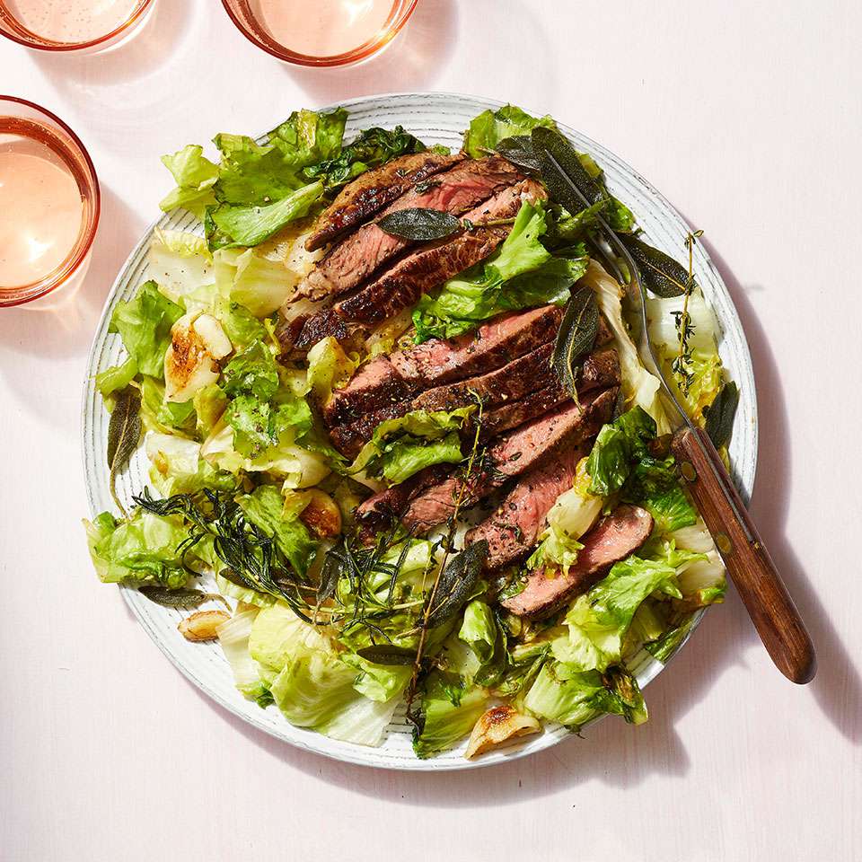 <p>This easy dinner takes just 20 minutes to prepare, meaning that seared steak can be a weeknight meal. Cooking herbs in the pan with the steak releases their aroma, infusing it into the meat while creating a crispy garnish. After the steaks and herbs are pan-seared, the escarole is cooked in the same skillet, so this healthy dinner requires minimal cleanup too. <a href="https://www.eatingwell.com/recipe/275771/pan-seared-steak-with-crispy-herbs-escarole/" rel="nofollow noopener" target="_blank" data-ylk="slk:View Recipe;elm:context_link;itc:0;sec:content-canvas" class="link ">View Recipe</a></p>