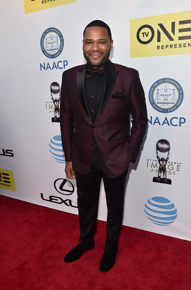 Anthony Anderson in a maroon tuxedo jacket with black lapels and a bowtie at the 47th NAACP Image Awards at Pasadena Civic Auditorium in Pasadena, California. 