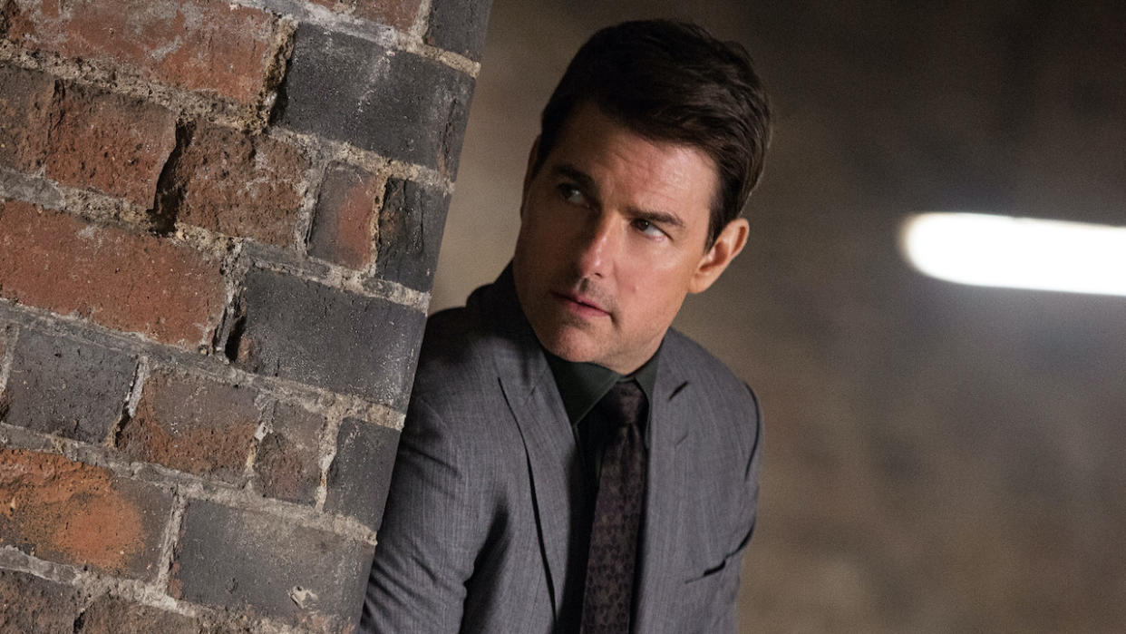  Tom Cruise peering past brick wall in Mission: Impossible - Fallout 