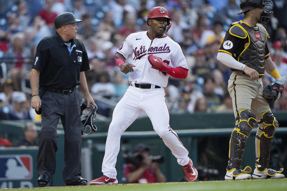 Washington Nationals' Stone Garrett scores next to San Diego Padres catcher Brett Sullivan during the second inning of a baseball game in Washington, Wednesday, May 24, 2023. (AP Photo/Manuel Balce Ceneta)