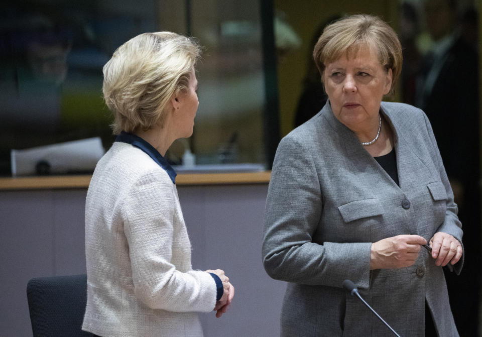 German Chancellor Angela Merkel, right, speaks with European Council President Ursula von der Leyen during a round table meeting at an EU summit in Brussels, Friday, Dec. 13, 2019. European Union leaders are gathering Friday to discuss Britain's departure from the bloc amid some relief that Prime Minister Boris Johnson has secured an election majority that should allow him to push the Brexit deal through parliament. (AP Photo/Olivier Matthys)