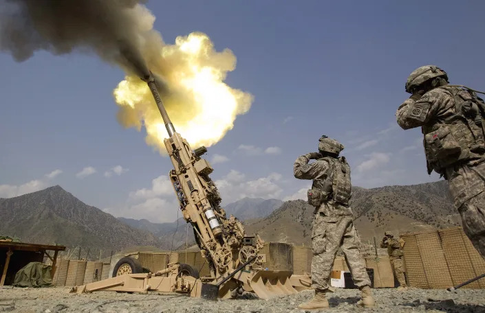 A round is fired from an M777 howitzer cannon.