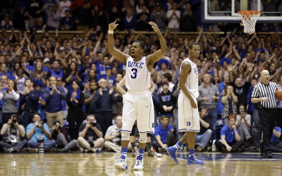 Duke's Tyler Thornton (3) and Rodney Hood, right, react near the end of an NCAA college basketball game against Maryland in Durham, N.C., Saturday, Feb. 15, 2014. Duke won 69-67. (AP Photo/Gerry Broome)